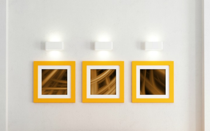 pictures on a bathroom wall with yellow frames
